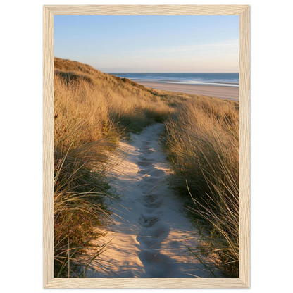 Sand track through amber marram grass to an empty beach at golden hour, print in a natural light wood frame