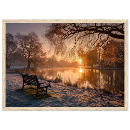 Frosted park lake at winter sunrise with an empty bench on the bank, print in a natural light wood frame