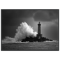 Storm spray rising past a lighthouse tower, monochrome print in a dark grey frame