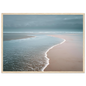 Minimalist coastal scene with foam edge on wet sand, framed in pale oak