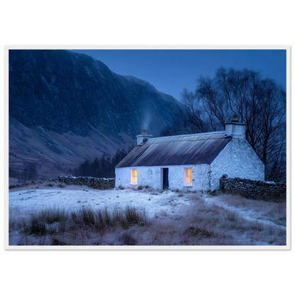 Scottish snow scene with a lit cottage, print in a white frame