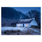 Scottish snow scene with a lit cottage, print in a white frame
