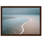 Empty beach and thin surf line, framed in dark brown wood with a wide mount