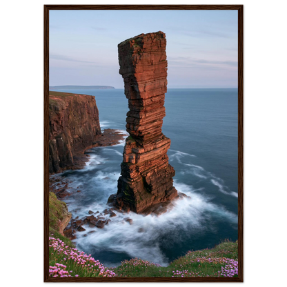 Red sandstone sea stack at last light above an Atlantic cliff coast, print in a dark brown wood frame