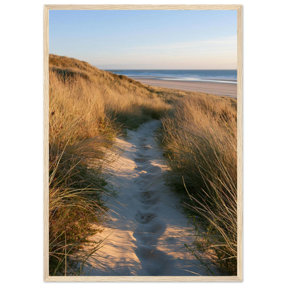 Sand track through amber marram grass to an empty beach at golden hour, print in a natural light wood frame