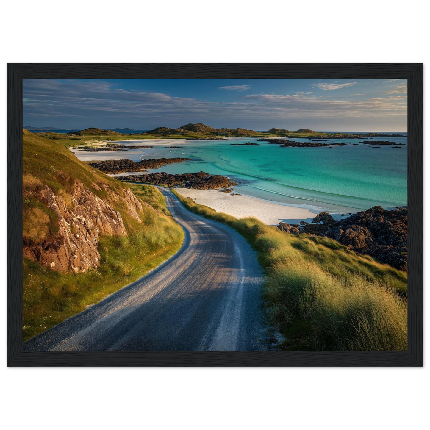 Single-track road above a white sand beach, framed in black
