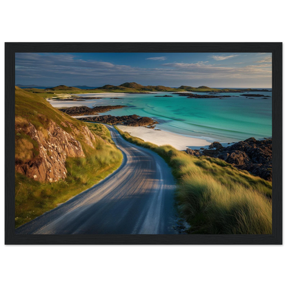 Single-track road above a white sand beach, framed in black