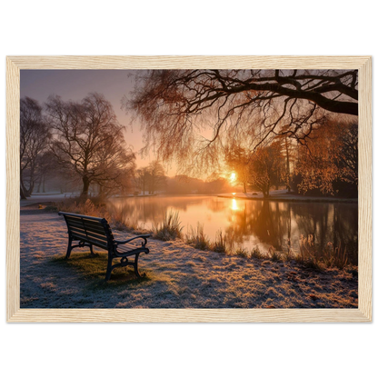 Frosted park lake at winter sunrise with an empty bench on the bank, print in a natural light wood frame