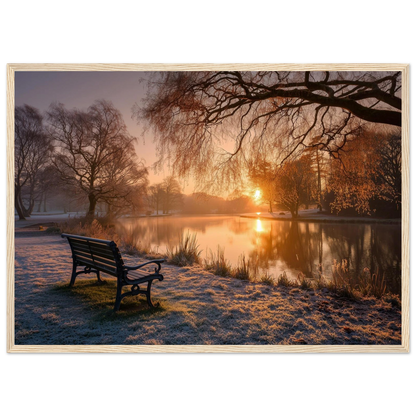 Frosted park lake at winter sunrise with an empty bench on the bank, print in a natural light wood frame