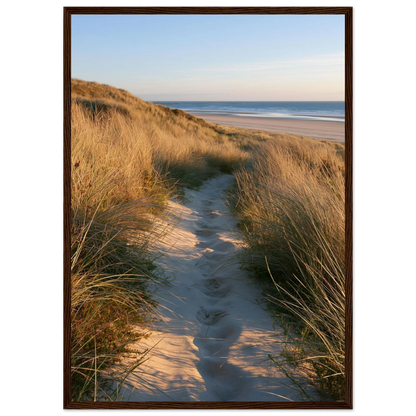 Sand track through amber marram grass to an empty beach at golden hour, print in a dark brown wood frame