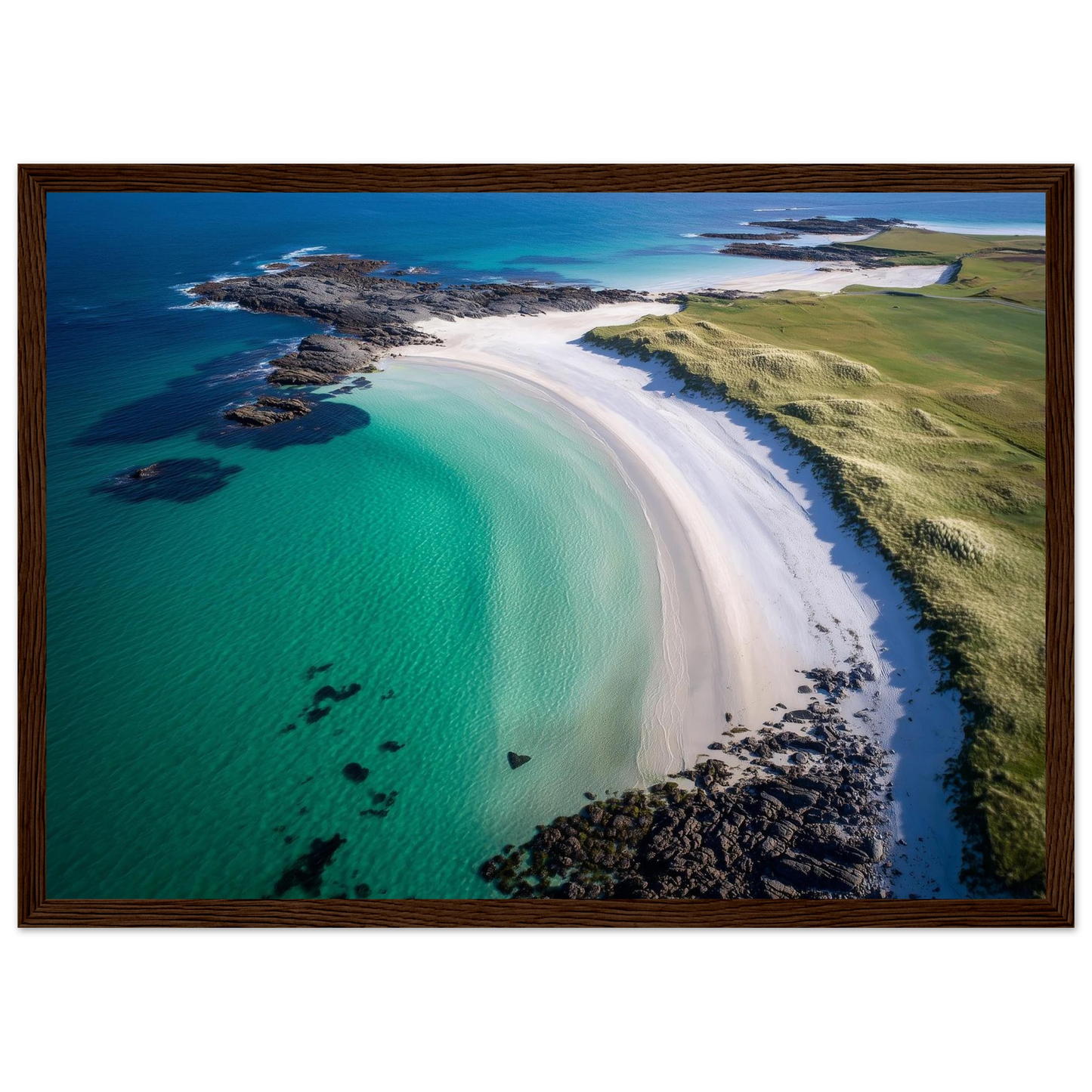 Aerial beach view with submerged rocks in clear water, framed in dark brown wood
