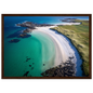 Aerial beach view with submerged rocks in clear water, framed in dark brown wood