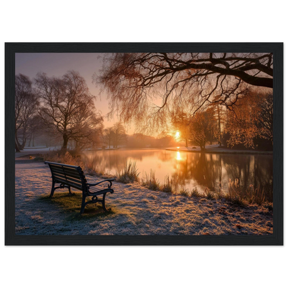 Frosted park lake at winter sunrise with an empty bench on the bank, print in a black frame