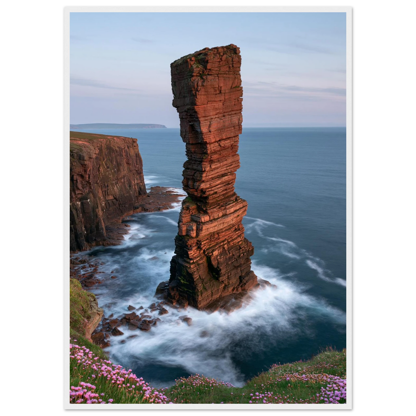 Red sandstone sea stack at last light above an Atlantic cliff coast, print in a white frame