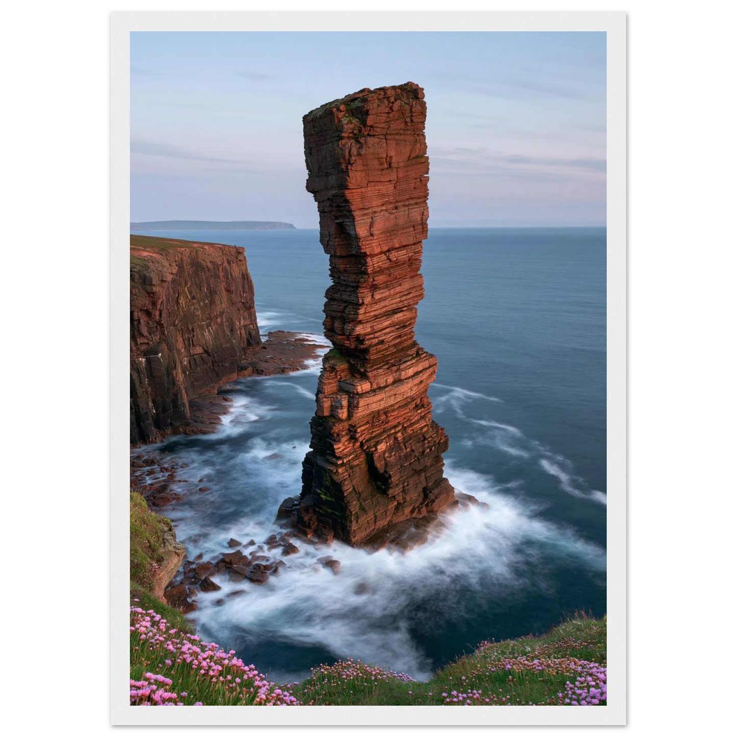 Red sandstone sea stack at last light above an Atlantic cliff coast, print in a white frame