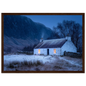 White croft under snow at blue hour, framed in dark walnut