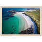 Curved beach and green machair from above, framed in pale oak with a wide mount