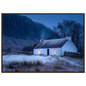 Snowy Scottish croft at dusk, framed print in a dark red-brown wood frame