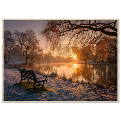 Frosted park lake at winter sunrise with an empty bench on the bank, print in a natural light wood frame