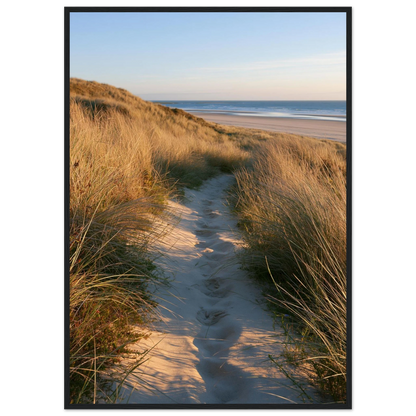 Sand track through amber marram grass to an empty beach at golden hour, print in a black frame