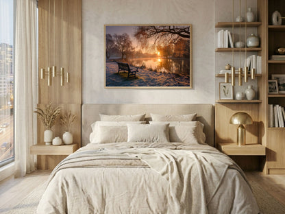 Frosted park lake at winter sunrise, framed in light wood above a bed in a warm neutral bedroom