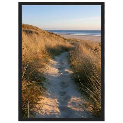 Sand track through amber marram grass to an empty beach at golden hour, print in a black frame