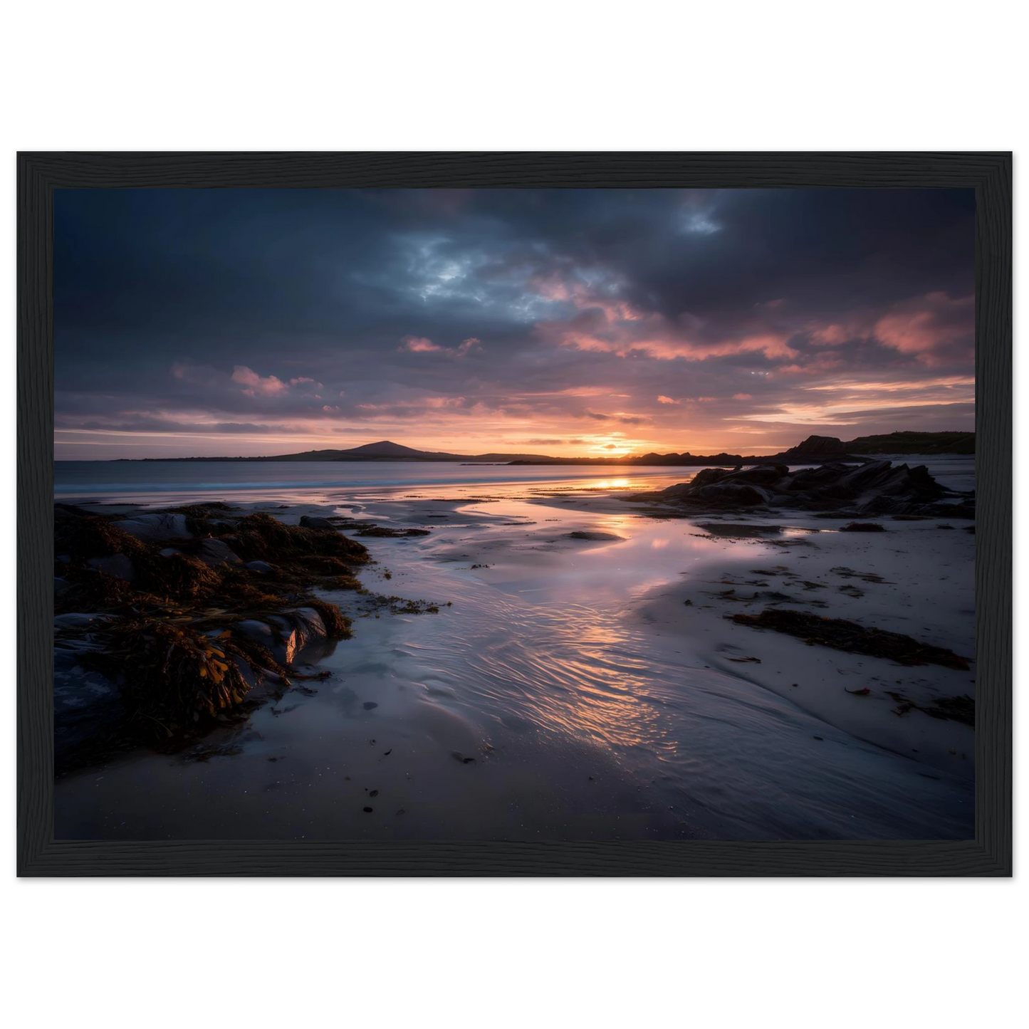 Moody seascape of a beach at last light, framed in charcoal
