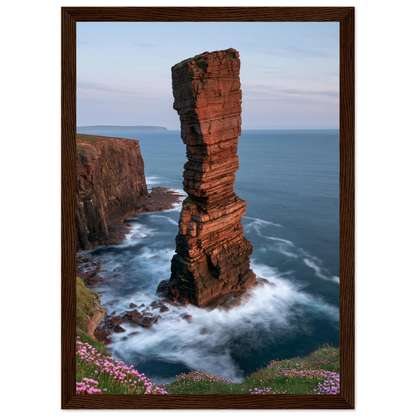 Red sandstone sea stack at last light above an Atlantic cliff coast, print in a dark brown wood frame
