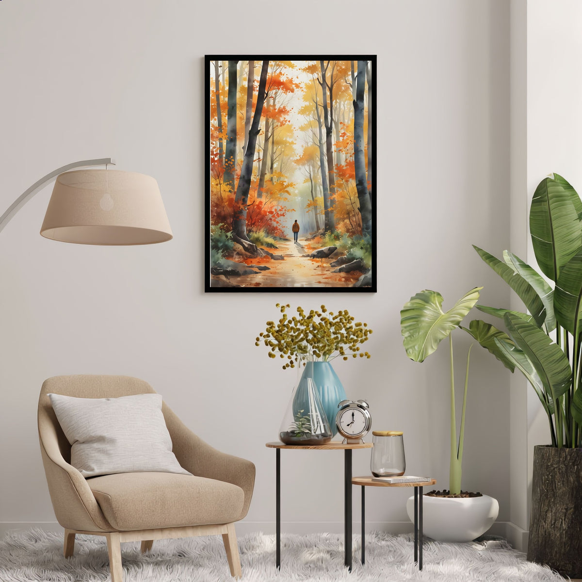 Autumn Woodland Path, in a black frame above a cream armchair and side table with a floor lamp in a light living room