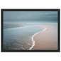Empty beach at the water's edge, print in a black frame with a wide mount