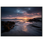 Empty beach at sunset with a gold light path, framed in dark grey