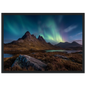 Northern lights and stars over a dark Highland ridge, framed in white