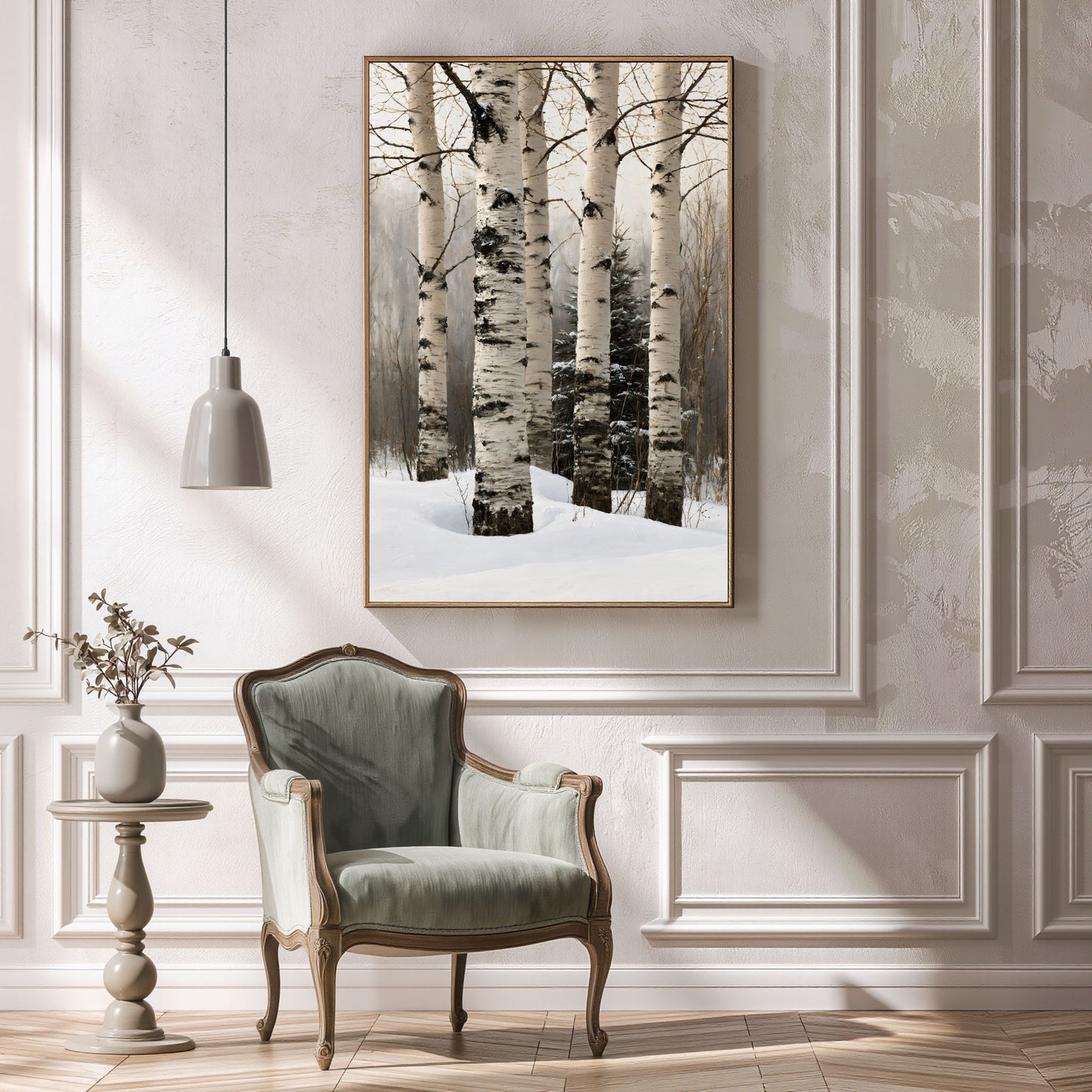 Birch trunks in deep snow, in a slim gold frame above a green armchair in a panelled hallway