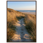 Sand track through amber marram grass to an empty beach at golden hour, print in a dark brown wood frame