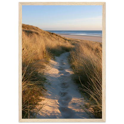 Sand track through amber marram grass to an empty beach at golden hour, print in a natural light wood frame