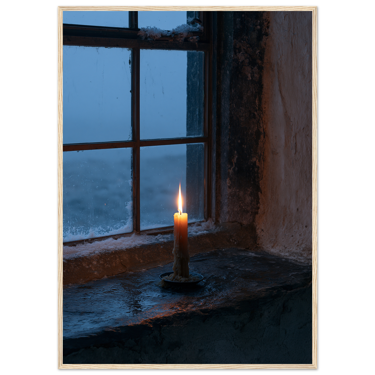 Candle burning on a stone windowsill at blue dusk, print in a natural wood frame