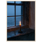 Candle burning on a stone windowsill at blue dusk, print in a natural wood frame