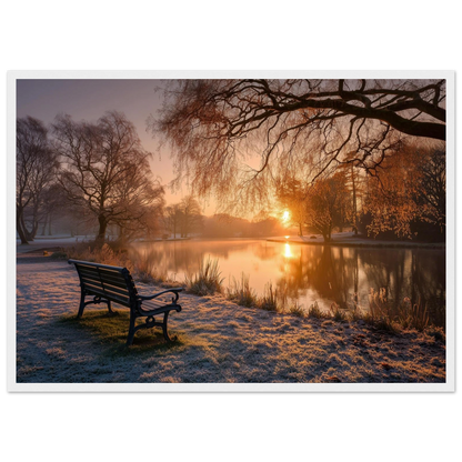 Frosted park lake at winter sunrise with an empty bench on the bank, print in a white frame