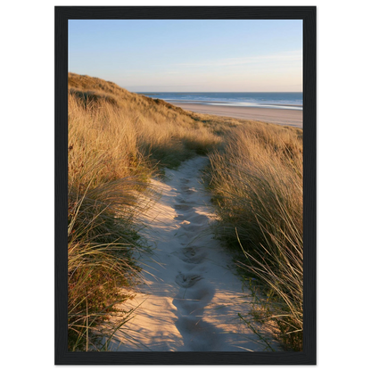 Sand track through amber marram grass to an empty beach at golden hour, print in a black frame