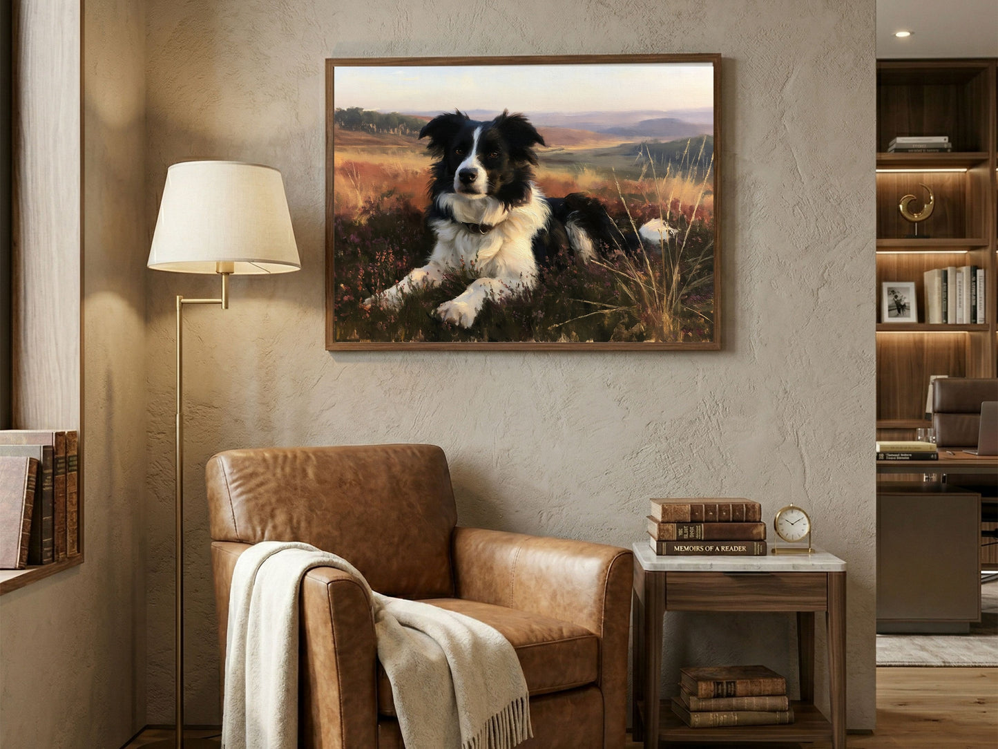 Border collie on a heather hill, framed in dark wood above a tan leather armchair in a panelled reading corner