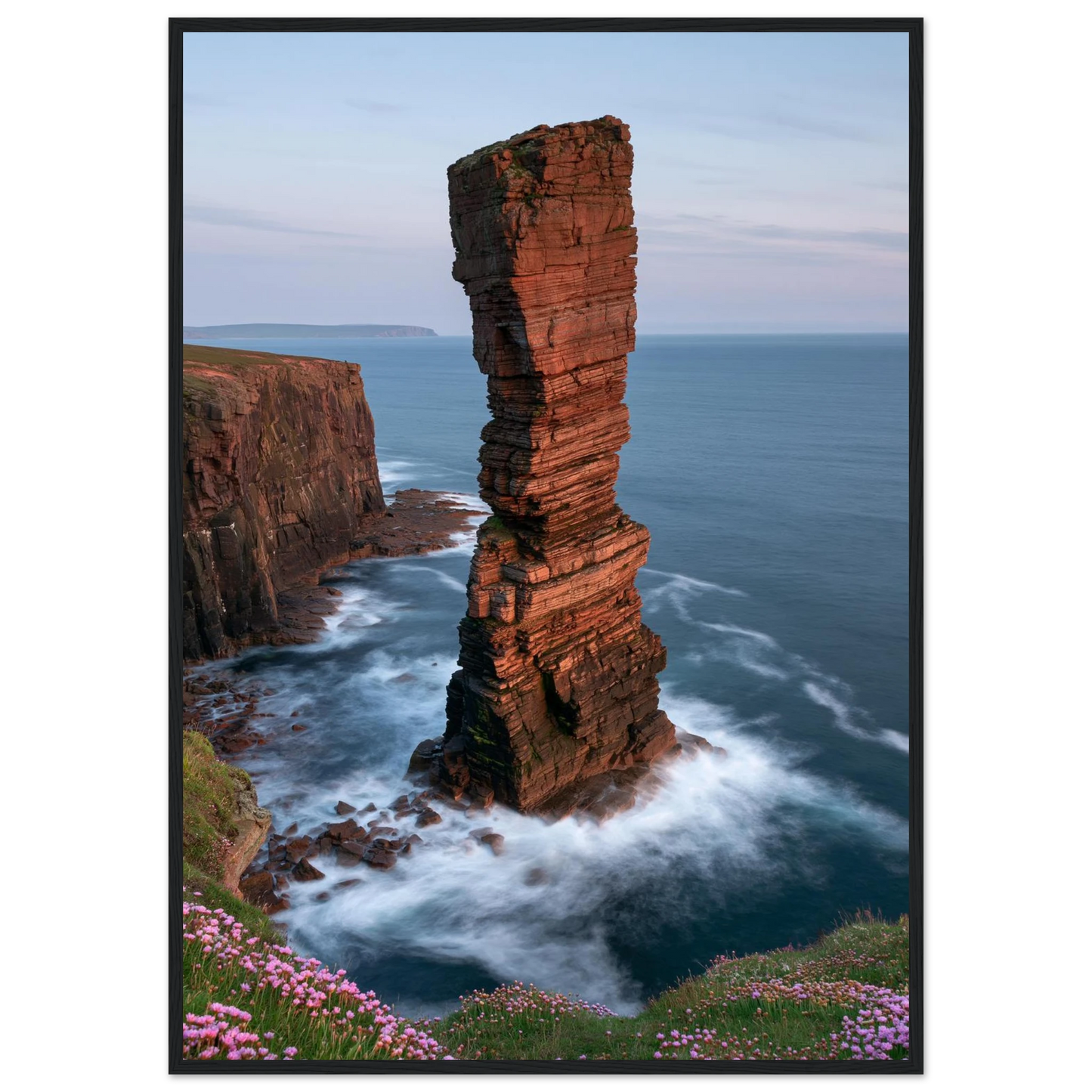 Red sandstone sea stack at last light above an Atlantic cliff coast, print in a black frame
