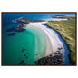 Hebridean beach from above with jade shallows and white sand, framed in dark brown wood
