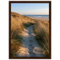 Sand track through amber marram grass to an empty beach at golden hour, print in a dark brown wood frame