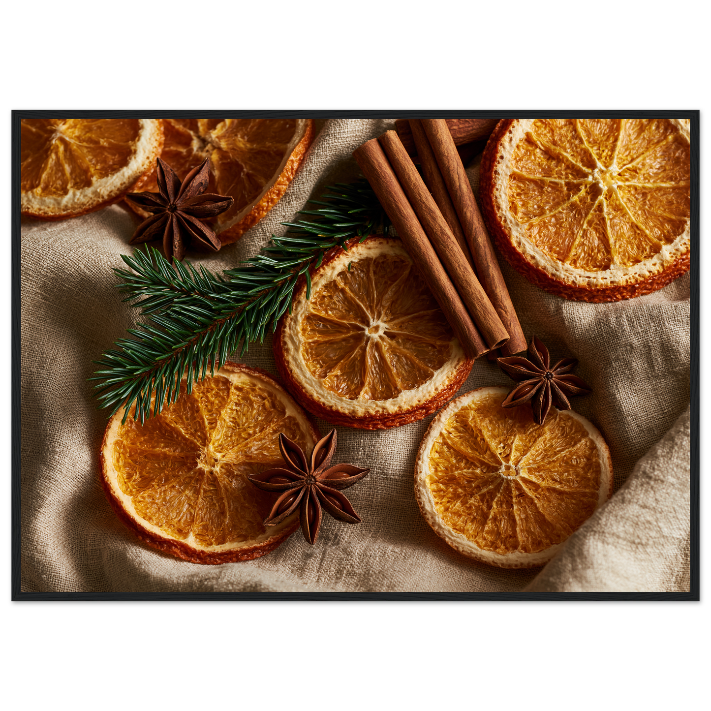 Dried oranges, cinnamon and star anise on linen, print in a black frame