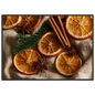 Dried oranges, cinnamon and star anise on linen, print in a black frame