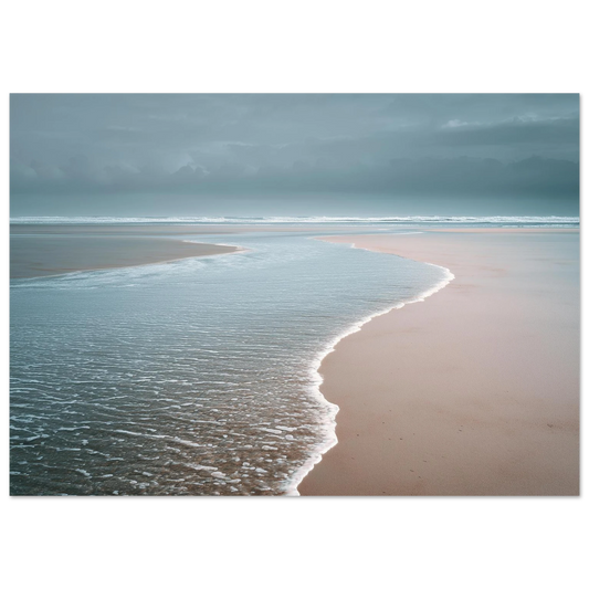 A thin sheet of water sliding back over pale wet sand under a grey sky, minimalist beach scene, print in a slim dark frame