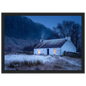 Lit croft against a dark mountain at dusk, framed in black