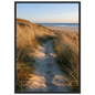 Sand track through amber marram grass to an empty beach at golden hour, print in a black frame