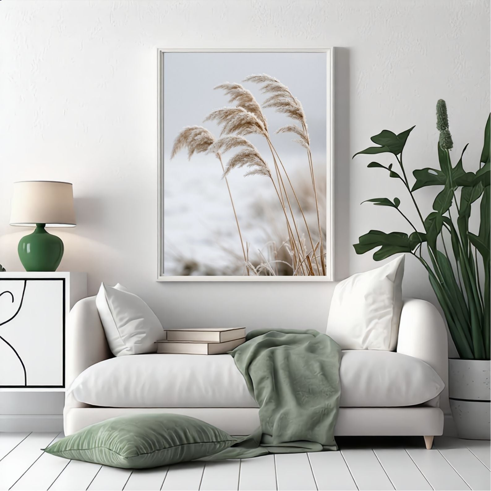 Frosted reeds print in a white frame above a white sofa in a bright living room