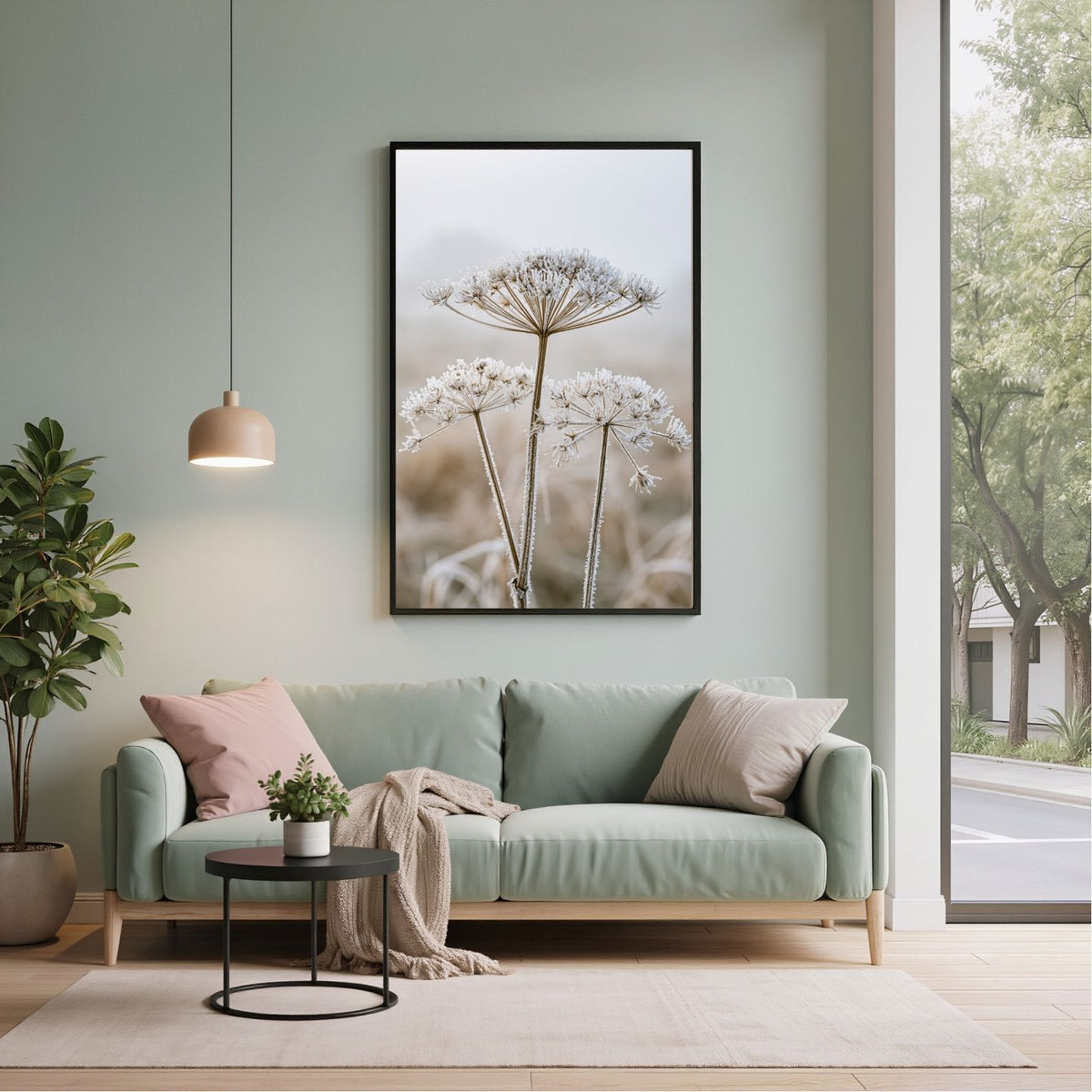 Frosted seedhead print in a black frame above a mint green sofa in a sage living room